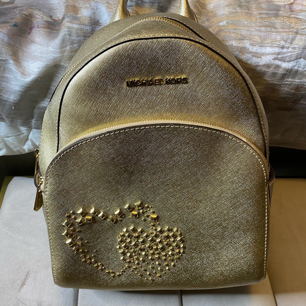 Michael Kors gold backpack and matching wallet